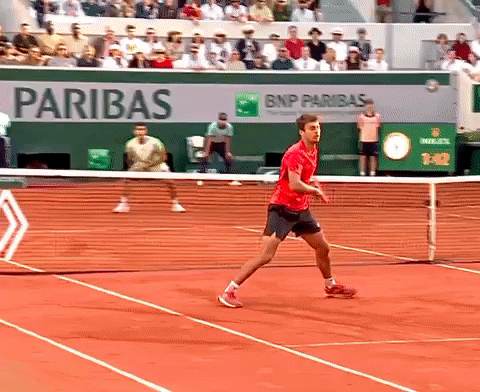 Man in Red Shirt Playing Tennis by BNP Paribas Ad