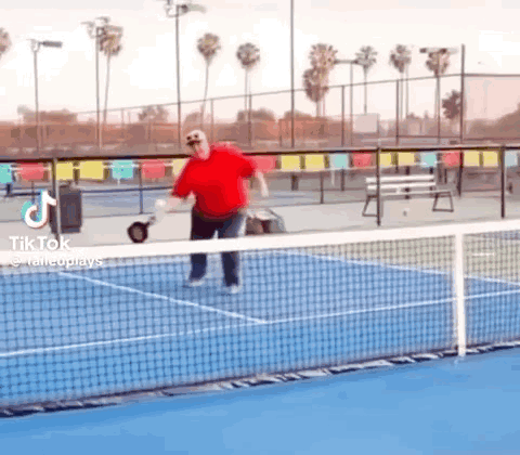Man in Red Shirt Playing Tennis