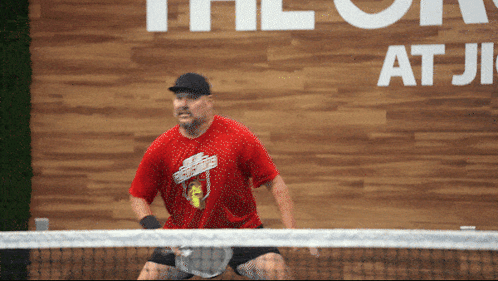 Man in Red Shirt Playing Tennis The on at ji