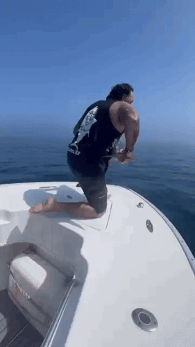 Man in Red Shirt Riding Boat Saying Triathlon
