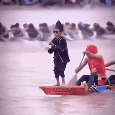 Man in Red Shirt Rowing Boat With Chinese Writing
