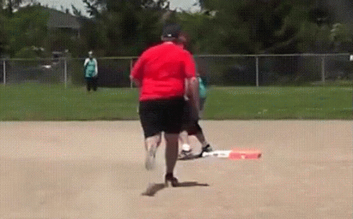 Man in Red Shirt Running on Baseball Field