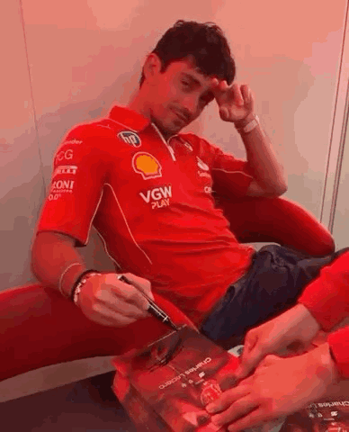 Man in Red Shirt Signing Book