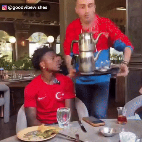 Man In Red Shirt Sitting At Table GIF