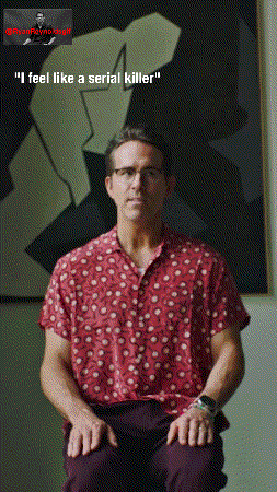 Man In Red Shirt Sitting In Front Of Painting GIF