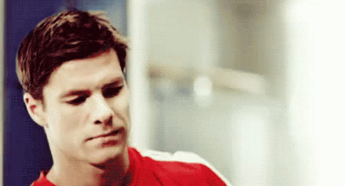 Man in Red Shirt Sitting in Locker Room