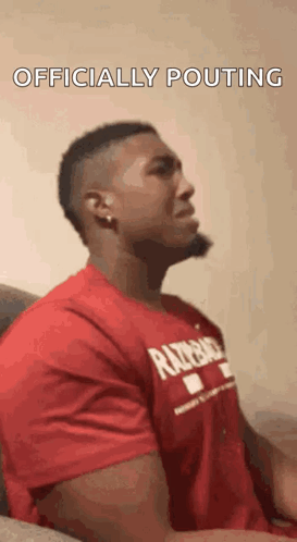 Man in Red Shirt Sitting on Couch Head Down