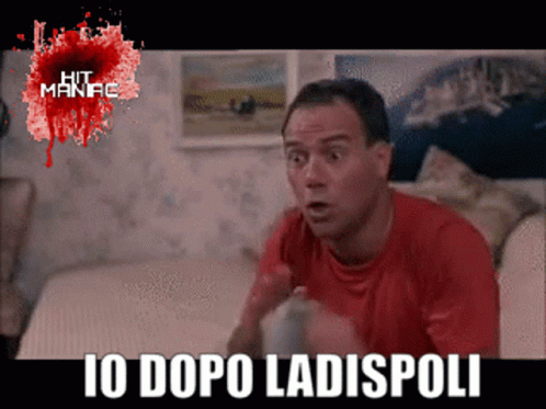 Man In Red Shirt Sitting On Couch Saying Io Dopo Ladispoli GIF
