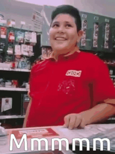 Man In Red Shirt Standing At Store Counter GIF