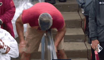 Man In Red Shirt Standing On Stairs GIF