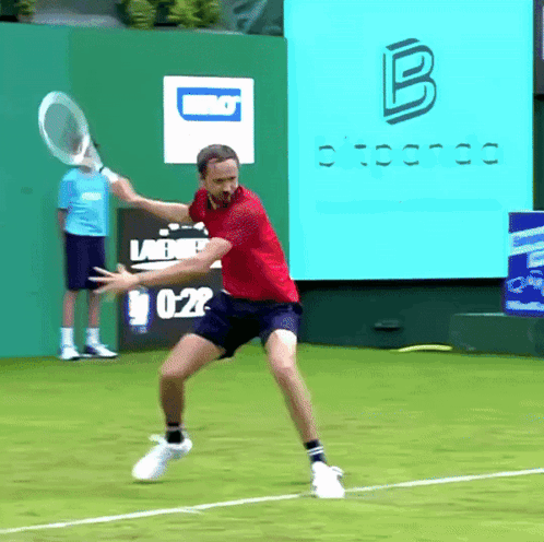 Man in Red Shirt Swinging Tennis Racket