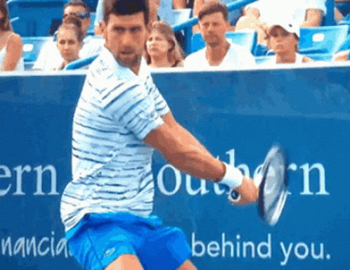 Man in Red Shirt Swinging Tennis Racquet