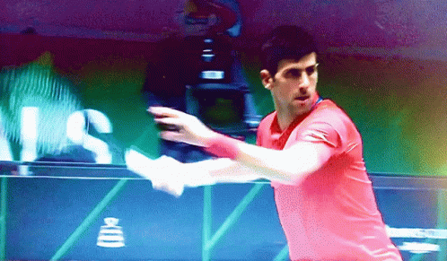 Man in Red Shirt Swinging Tennis Racquet with US Sign