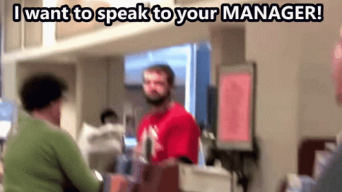 Man in Red Shirt Talking to Woman in Green Sweater Saying I Want to Speak to Your Manager