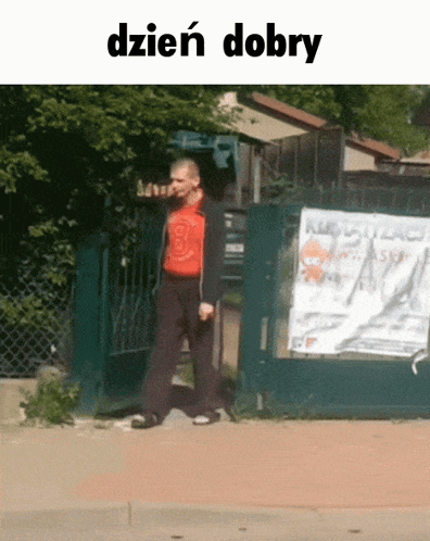 Man In Red Shirt Walking Past Dzien Dobry Sign GIF