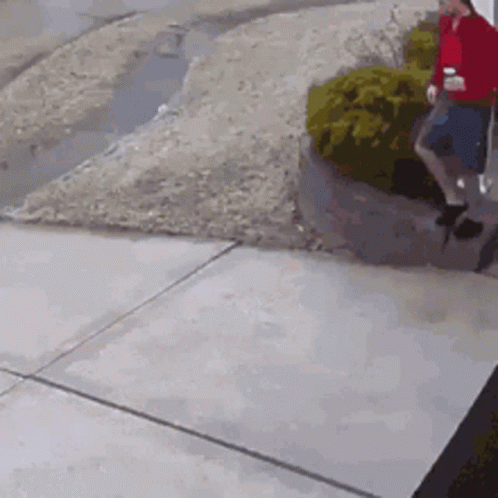 Man in Red Shirt Walking with Coffee