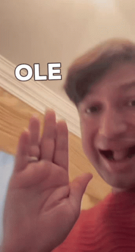 Man in Red Shirt Waving Ole