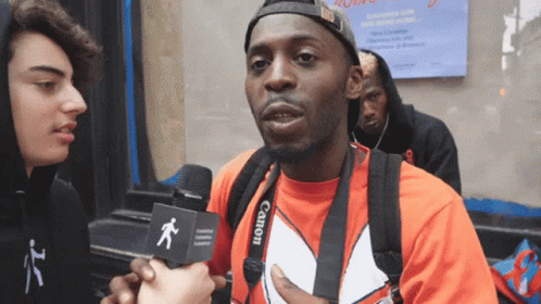 Man In Red Shirt With Camera Strap GIF