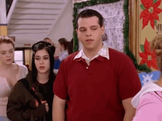 Man in Red Shirt with Group in Hallway
