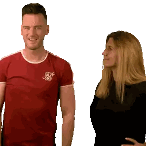 Man in Red Shirt with S Next to Woman