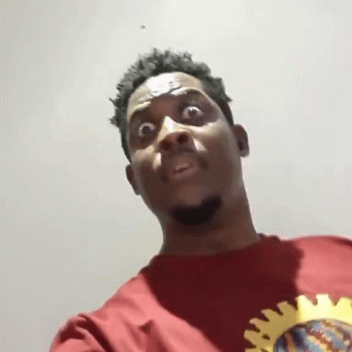Man in Red Shirt With Yellow Sun Making Funny Face