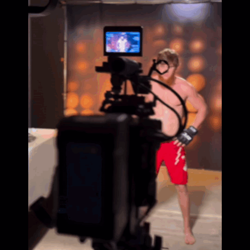 Man in Red Shorts in Front of Camera
