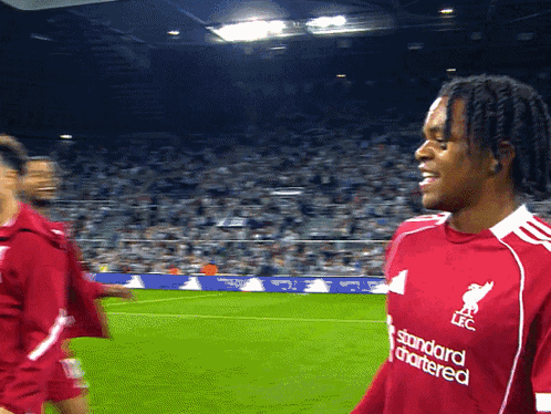 Man in Red Standard Chartered Shirt