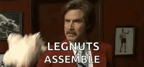 Man In Red Suit And Tie Holding Cotton Candy Saying Legnuts Assemble GIF