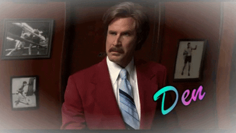 Man in Red Suit and Tie Saying Den