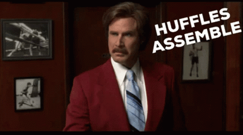 Man in Red Suit and Tie Saying Huffles Assemble