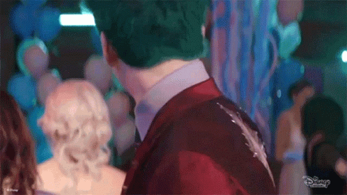 Man in Red Suit and Woman in White Dress at Party