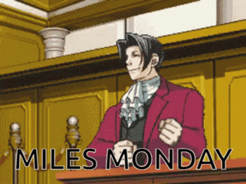 Man In Red Suit At Podium Miles Monday GIF