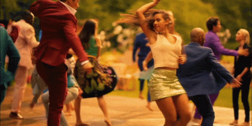 Man In Red Suit Carrying Woman In Green Skirt GIF