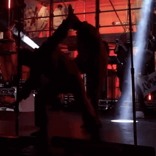 Man in Red Suit Doing Trick on Stage