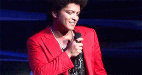 Man in Red Suit Holding Microphone