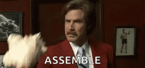 Man In Red Suit Saying Assemble With White Object GIF