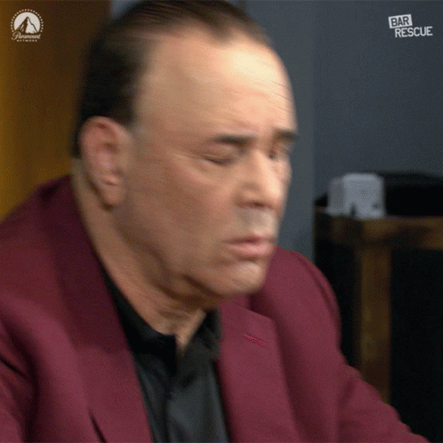 Man in Red Suit Sitting in Front of Bar Rescue Sign