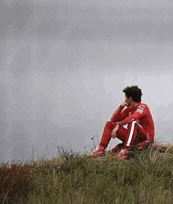 Man in Red Suit Sitting on Hill