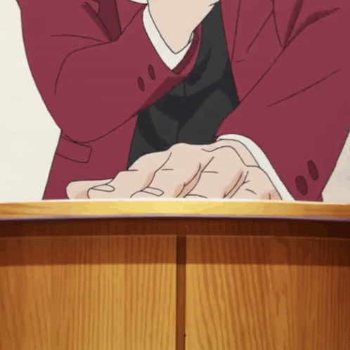 Man in Red Suit Sitting With Hands Folded
