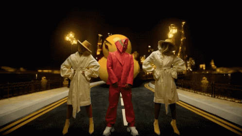 Man in Red Suit With Two Women in Bathrobes