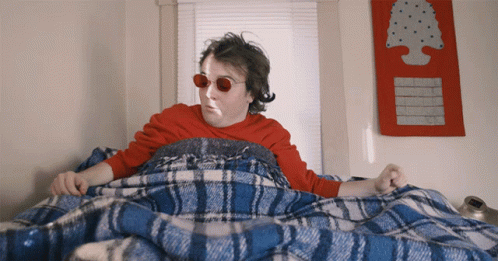 Man in Red Sunglasses Under Blue and White Blanket