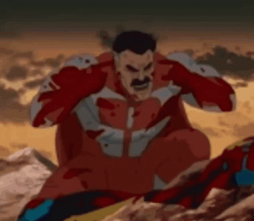 Man in Red Superhero Costume Sitting on Rock Covering Ears