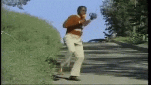Man In Red Sweater Running Down Road GIF