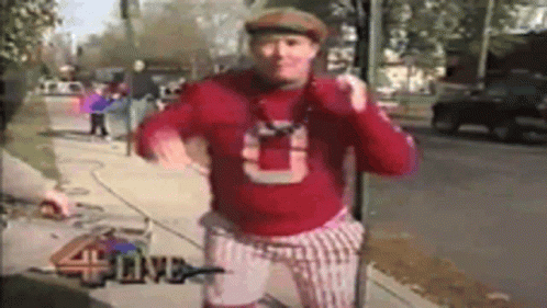 Man in Red Sweater With Letter U on Sidewalk
