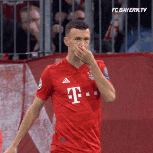 Man in Red T-Mobile Jersey Covering Nose