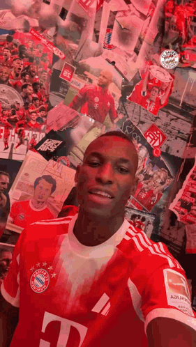 Man in Red T-Mobile Jersey Taking Selfie at Picture Wall