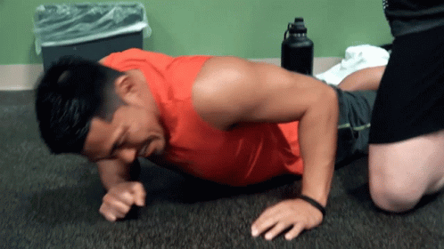 Man in Red Tank Top Doing Push Ups