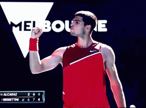 Man In Red Tank Top Standing At Melbourne Sign GIF