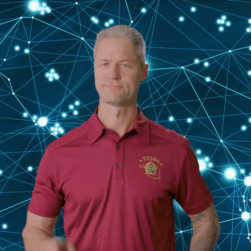 Man in Red Tulsa Polo Shirt Pointing Finger