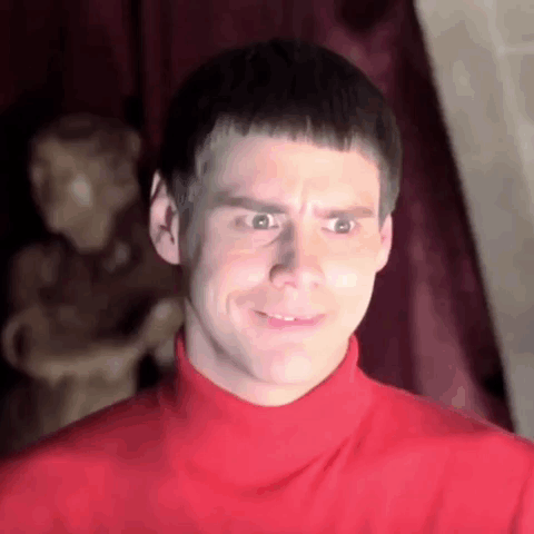 Man In Red Turtleneck Making Funny Face At Statue GIF